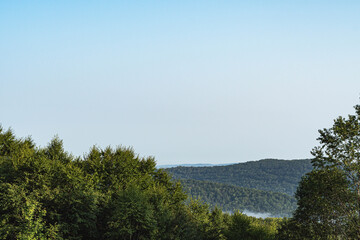 Stuning morning fog over mountain valley showing cloud covered mountain tops, summer background, natural authentic