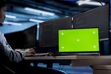 Isolated screen laptop in data center facility managing rackmounts energy consumption. Chroma key...