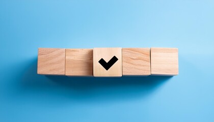 wood cube with check mark on blue background checklist concept copy space