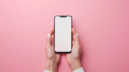 A smartphone with a blank screen held by two hands on a pink background