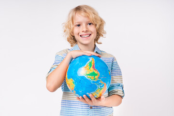 Smiling caucasian blond little small preteen boy male child kid elementary primary middle school pupil teenager holding globe to protect the planet isolated over white background