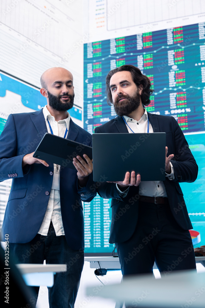 Poster diverse group of business specialists solve their daily tasks in control room with big screen, analy