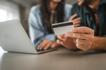 adult couple buy online on laptop with credit card at home