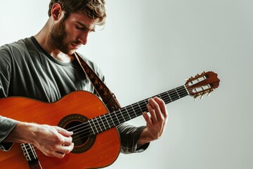 Obraz premium man playing a guitar A man playing a guitar standing isolated on white background