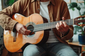 Fototapeta premium Colombian man playing and studying guitar in his room. Acoustic and harmonic instrument.