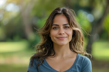 Confident Hispanic woman smiling in park.