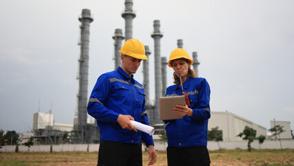 Engineer couple man and woman working at industrial chemical plant