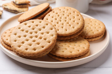 Tasty sandwich cookies on light table, closeup