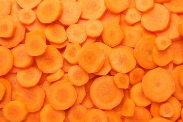 Slices of fresh ripe carrot as background, top view
