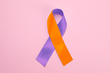 World Psoriasis Day. Orange and orchid awareness ribbon as symbol of support on pink background,...