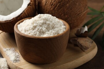 Coconut flour in bowl and fresh fruits on table, closeup