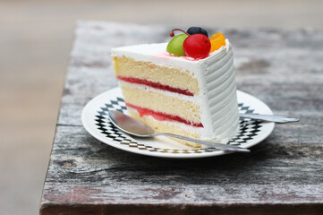 piece of beautiful cake on dish with fresh fruits