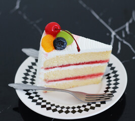 piece of beautiful cake on dish with fresh fruits