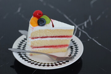 piece of beautiful cake on dish with fresh fruits