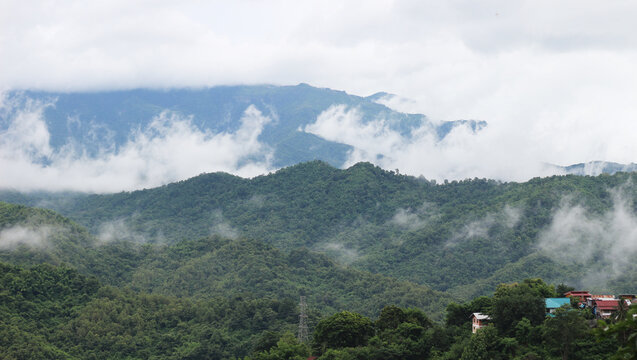 the clouds are rolling in on the mountains