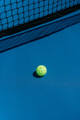 pickleball on a blue court