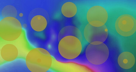Image of yellow light spots over colourful shapes on blue background