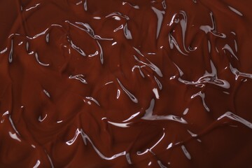 Delicious melted chocolate as background, top view