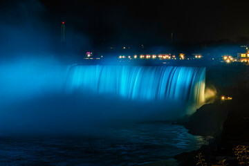 Night image of the Niagara Fallls  illuminated by blue lights , Ontario, Canada