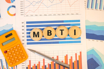 This photo features wooden dice spelling MBTI,