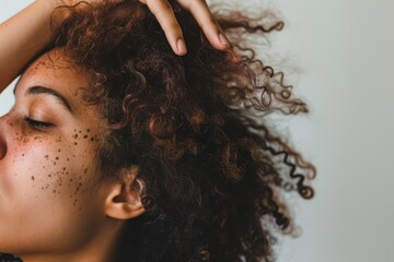 Fototapeta premium Young Woman With Curly Hair Playfully Touching Her Hair at Home