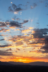 Colorful sunrise behind the San Gabriel Mountains in Los Angeles California.  Vertical photo taken in the hills above Chatsworth in the San Fernando Valley.