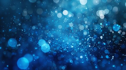 Abstract blue background with bokeh lights and sparkling particles.