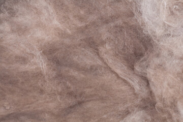 Construction worker mineral wool thermally insulating house attic with glass wool