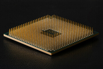 Low angle view of CPU processor chip pin side up isolated on black