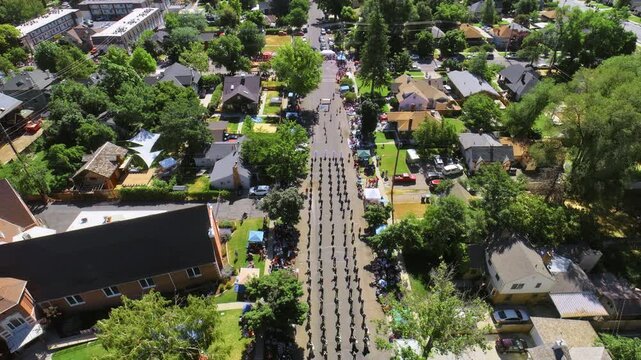 Parade through suburban neighborhood - drone shot