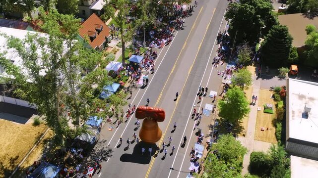 Independence day parade and liberty bell balloon - drone shot