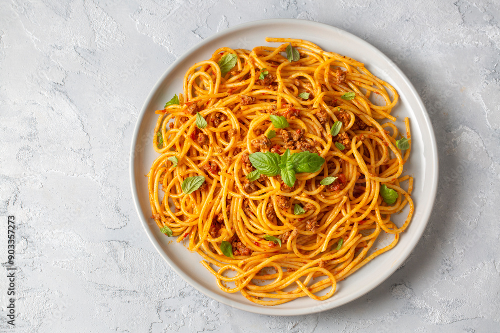 Wall mural Pasta spaghetti bolognese with minced beef sauce, tomatoes, parmesan cheese and fresh basil in a plate