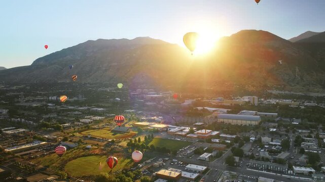 Beautiful sunrise silhouette on hot air balloon over Provo, Utah - drone shot