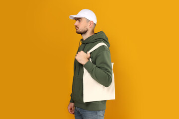 A guy in a thick coat with a bag on his shoulder