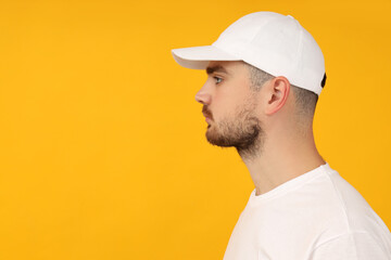 A young guy in a white T-shirt and a white cap
