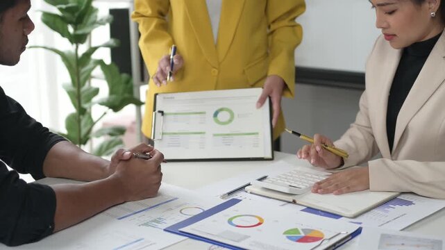Colleagues analyzing financial data in a modern office meeting
