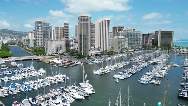 Ala Wai harbor boats with hotels and condos in the Waikiki area of Honolulu on Oahu, Hawaii. 