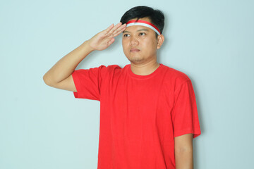 Fototapeta premium Indonesian man give salute pose. Wearing a red t-shirt