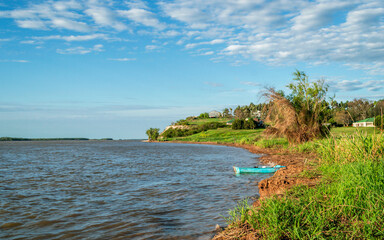 
Beautiful postcard of the Parana River, where we see a small fishing canoe, a large cloudy and blue sky, we also see great green vegetation and beautiful parks in the province of Entre Rios Arg.