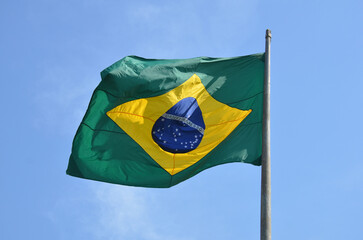 Flag of Brazil fluttering in the wind. In the center of the flag with the words "order and progress" in Portuguese. flag day. proclamation of the Republic. proclamação da república