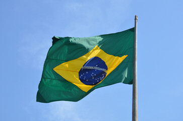 Flag of Brazil fluttering in the wind. In the center of the flag with the words "order and progress" in Portuguese. flag day. proclamation of the Republic. proclamação da república