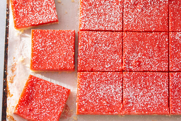 Tray of Rhubarb Custard Bars From Above Sprinkled with  Powdered Sugar