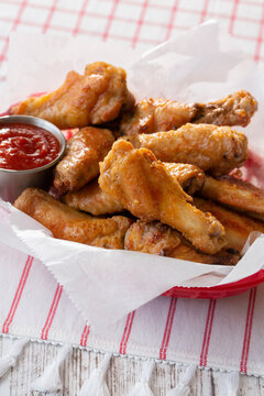 Basket of Old Bay Maryland Style Chicken Wings with side of Cocktail Sauce