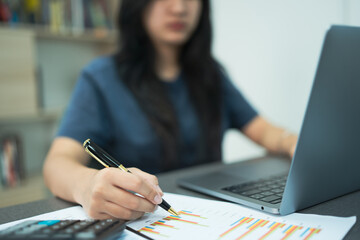 Woman working on desk with using calculator, finance accounting.
