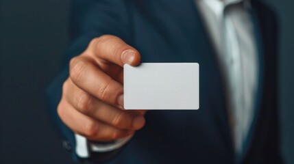Close up shot of a person s hand offering a business card during a formal corporate meeting or interview with a blurred background highlighting the business professional and networking context