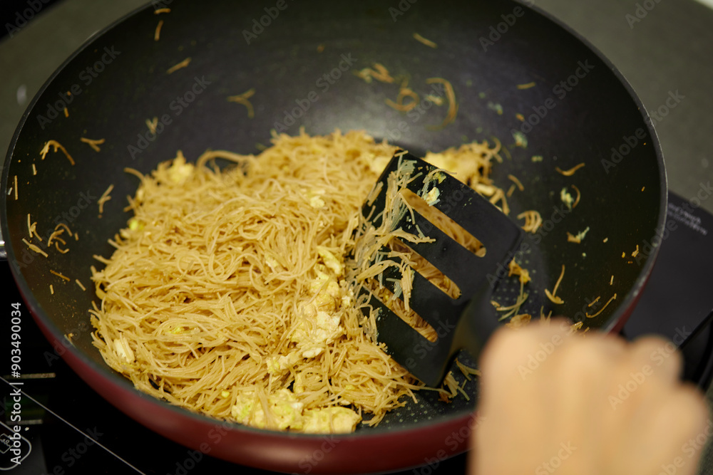 Wall mural Close-up of stir-fry Rice Vermicelli with eggs in cooking pan 