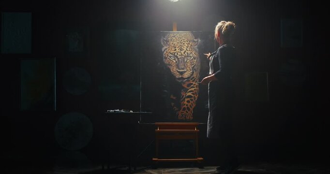 Woman Standing in Front of Leopard Painting