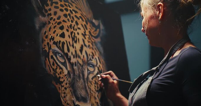 Woman Painting Leopard on Canvas