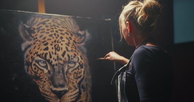 Woman Painting Leopard on Easel
