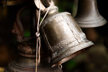 An antique brass bells hanging in buddhism temple